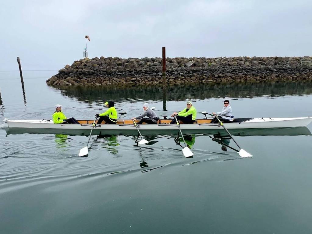 Photo by Doug Schwarz photo for Sequim Bay Yacht Club
Sequim Bay Yacht Club rowing co-captain Jeanne Neal, far left, coxed the clubs training shell when prospective rowers tried out sculling during the May 5 Opening Day of Boating Season.