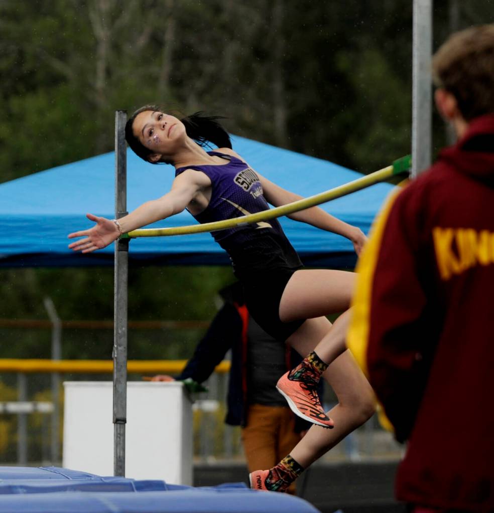 Sequim freshman Clare Turella leaps over the high jump bar en route to a district championship, eventually clearing a personal-best 5-3 in the West Central B-district meet event in Belfair on May 18.