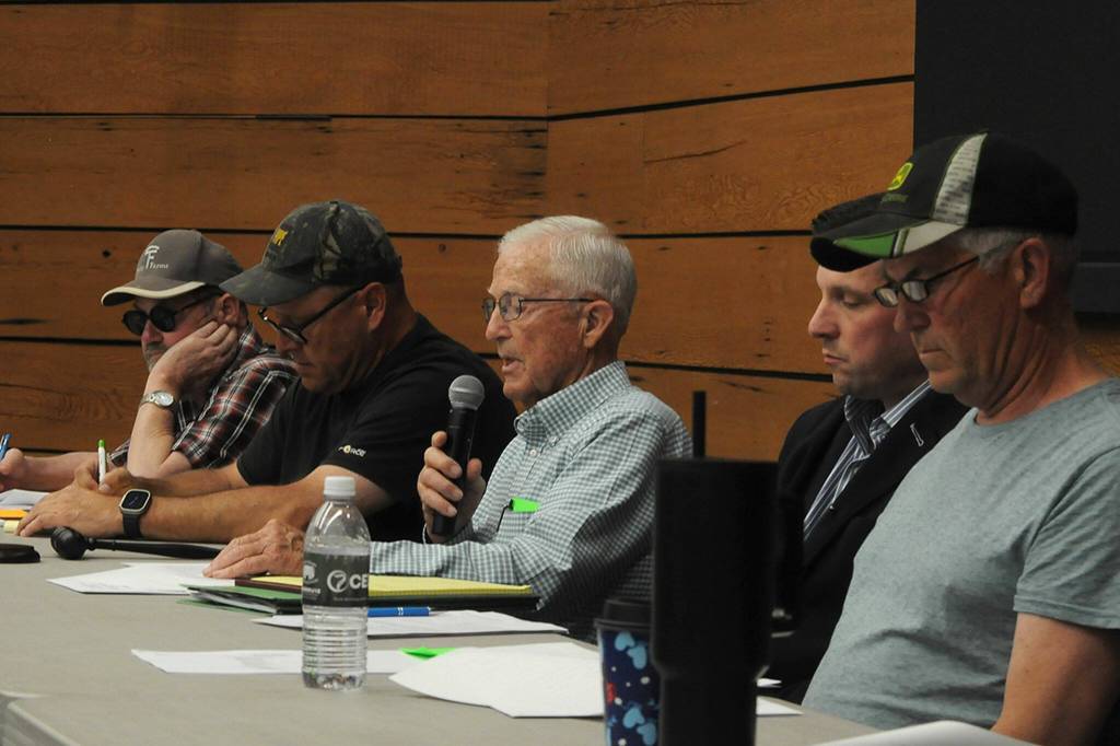 Sequim Gazette photo by Matthew Nash/ Gary Smith, center, reads a statement to shareholders of the Sequim Prairie Tri-Irrigation Association on May 14 inside the Dungeness River Nature Center that their special meeting is meant to continue the 2024 annual meeting after it was disrupted and elect four board members, two for 2023 and 2024.