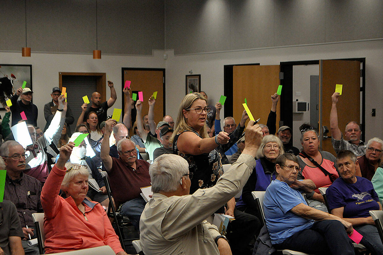 Sequim Gazette photo by Matthew Nash/ Julie Vig, secretary/treasurer for the Sequim Prairie Tri-Irrigation Association, tallies votes during a special meeting of shareholders. Board members continued the associations February annual meeting on May 14 after contention over proper notification about meetings and their legitimacy. Shareholders voted to reinstate board members from 2023.