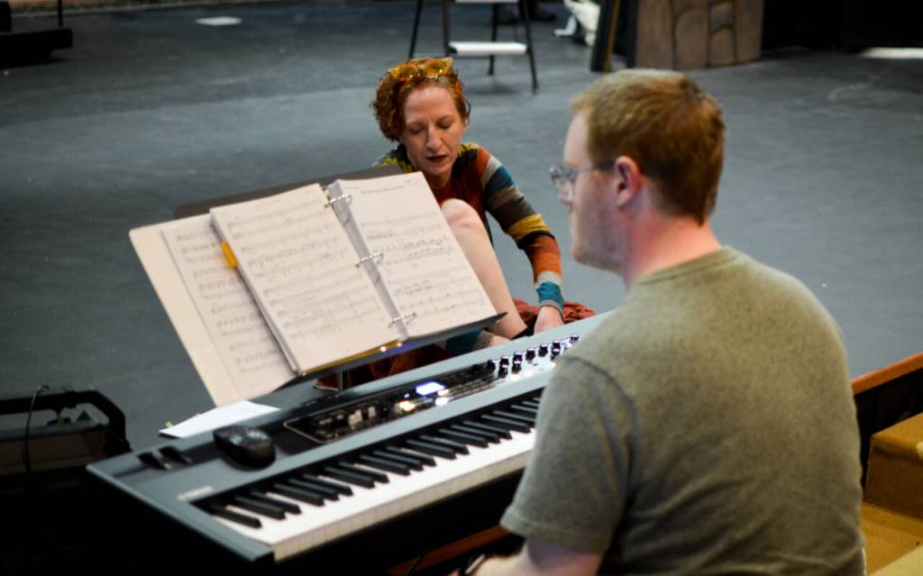Sequim Gazette photo by Elijah Sussman / Spamalot musical director Morgan Bartholick-LeMaire works on part with actor Susan Cates at Olympic Theatre Arts on May 15.