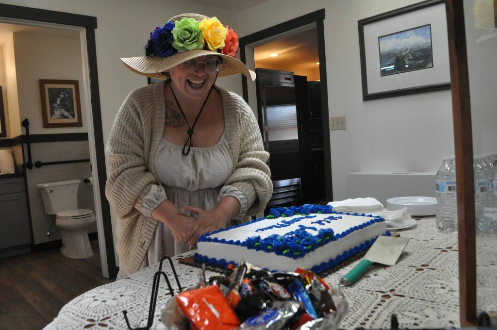 Sequim Gazette photo by Matthew Nash/ Sequim deputy mayor Rachel Anderson cuts the cake at the dedication for LtCol James Minsky Place.
