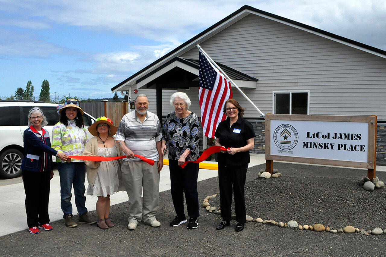 Sequim Gazette photos by Matthew Nash
Helen and Greg Starr, executors of James Minskys estate, cut the ribbon for LtCol James Minsky Place on May 17 with Cheri Tinker, executive director of Sarges Veteran Support, on right, and Sarges board president Lorri Gilchrist, and city councilors Harmony Rutter and Rachel Anderson. The facility will permanently house six disabled and/or elderly veterans in Sequim.