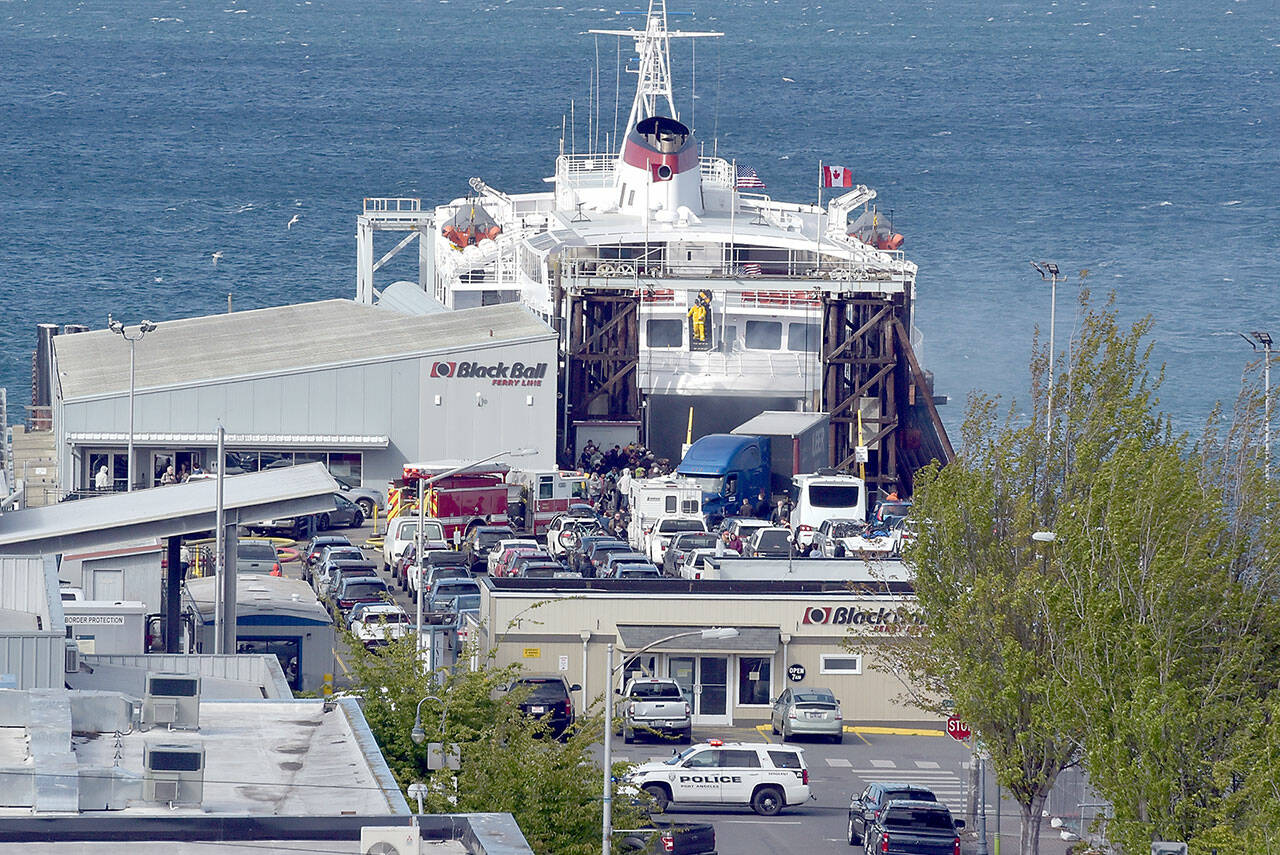 Photo by Keith Thorpe/Olympic Peninsula News Group / Smoke vents from the rear car deck doors as firefighters battle a vehicle fire aboard the ferry MV Coho upon its afternoon arrival in Port Angeles on May 16.