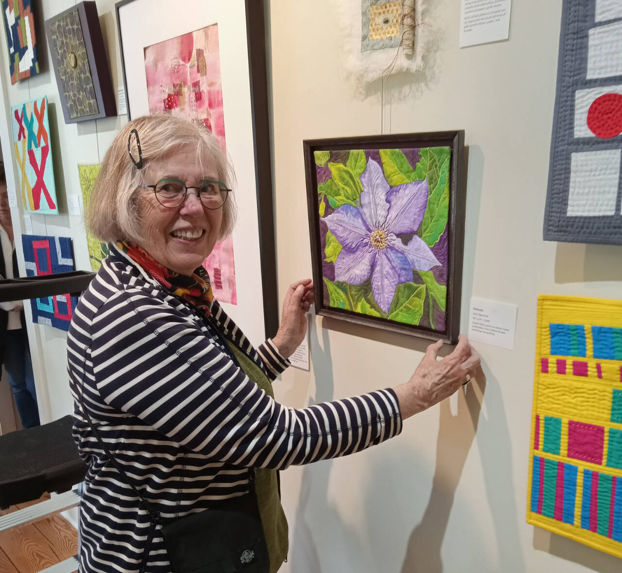 Photo courtesy of Peninsula Fiber Artists / Liisa Fagerlund of Sequim displays a bead-embellished floral image now on display at the A. Milligan Gallery on North Sequim Avenue.