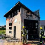 Photo courtesy Clallam County Fire District 3
Firefighters inspect a garage fire north of Sequim on May 19 that destroyed a trailer inside.