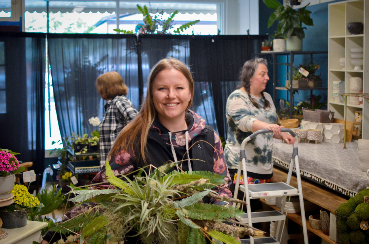 Sequim Gazette photo by Elijah Sussman / From left, Gail Ditmore, owner Lacey Lovell, and Sharrai Morgan put the finishing touches in Sofies Florists new Sequim location on May 21.