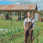 Sequim Gazette photo by Elijah Sussman / Jenson, farmer and SisterLand Farm Pride Picnic organizer, stands in a field of garlic on their farm in Port Angeles on May 22.
