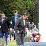 Sequim Gazette photo by Matthew Nash/ Nancy Zimmerman, chaplain for American Legion Post 62 places a wreath during a Memorial Day ceremony on May 27 in Sequim View Cemetery.