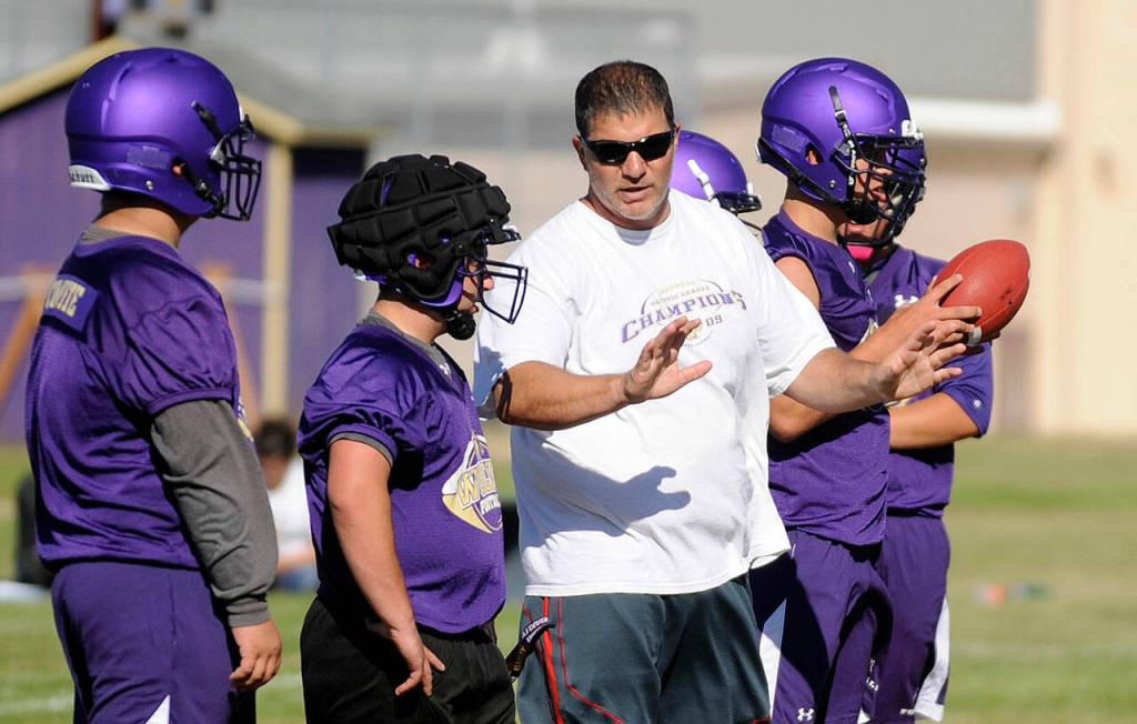 Sequim Gazette file photo by Michael Dashiell / Sequim High head coach Erik Wiker leads his football squad in a preseason practice in August 2017.