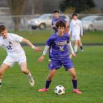 Sequim Gazette photo by Michael Dashiell / Sequims Joshua Alcaraz, center, tries to keep possession as in an Olympic League game against Bainbridge on March 26, was named to the all-Olympic League first team.