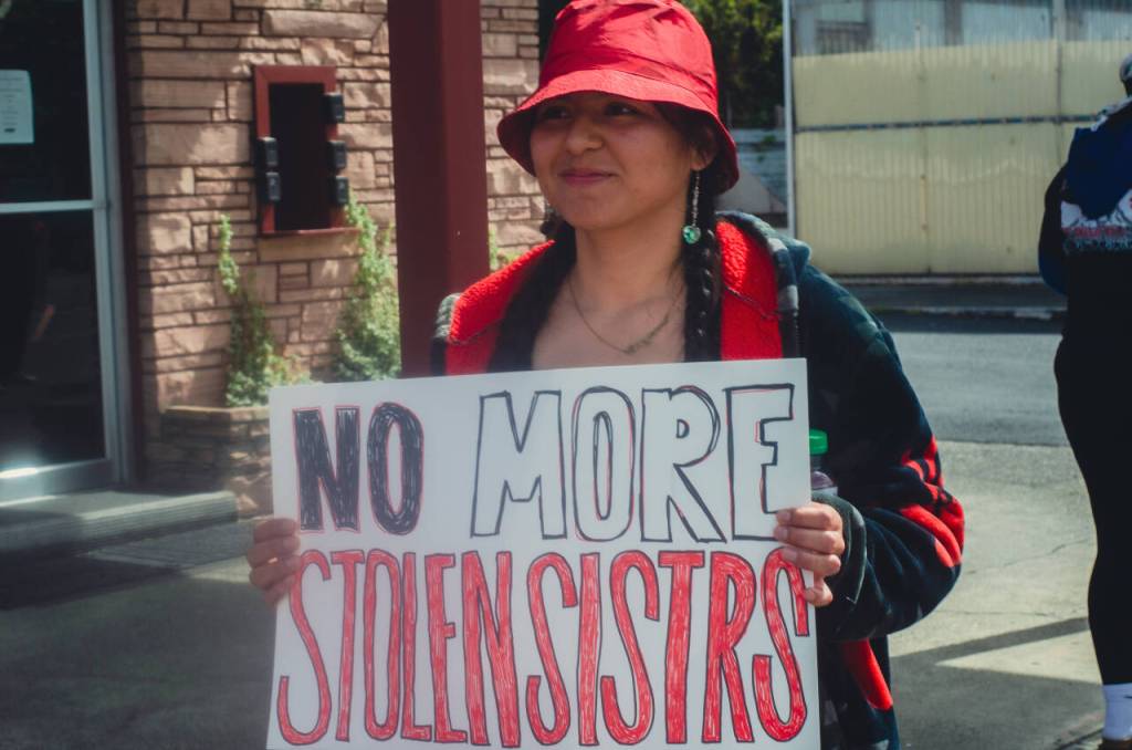 Sequim Gazette photo by Elijah Sussman / Cheyenne Wheeler holds a sign reading NO MORE STOLEN SISTERS on march from Elwha Cultural Heritage Center to Civic Field on May 3.
