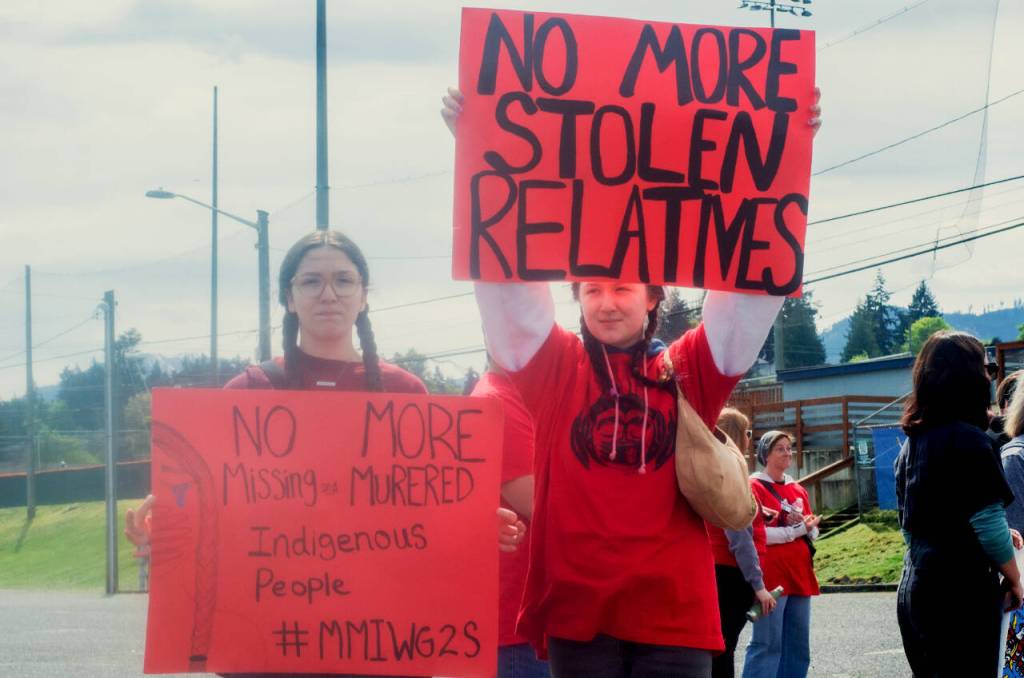 Sequim Gazette photo by Elijah Sussman / Sisters and Jamestown Sklallam members Sonni (left) and Jolie Creech of the Johnson family show their support for MMIP at the Civic Feild parking lot on May 3.