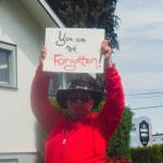 Sequim Gazette photo by Elijah Sussman / Sarah Raven Thomas of the Tlinget tribe of Anchorage Alaska passes by Church of Nazarene in Port Angeles Red Dress Day march on May 3.