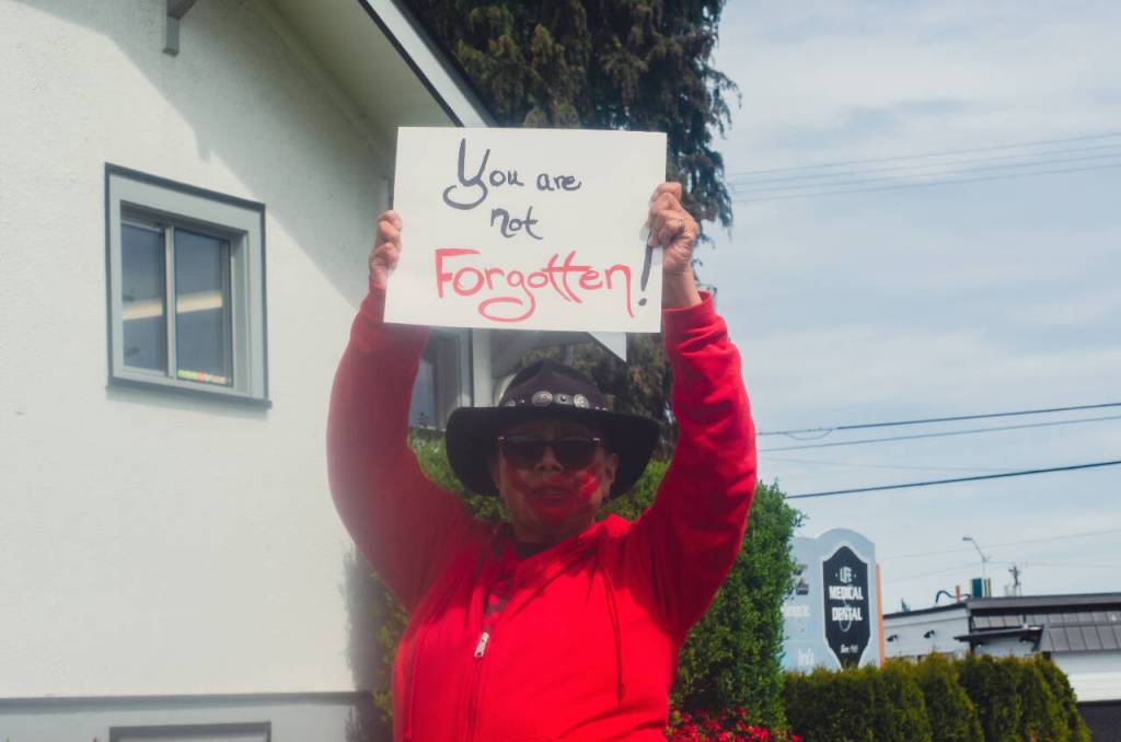 Sequim Gazette photo by Elijah Sussman / Sarah Raven Thomas of the Tlinget tribe of Anchorage Alaska passes by Church of Nazarene in Port Angeles Red Dress Day march on May 3.