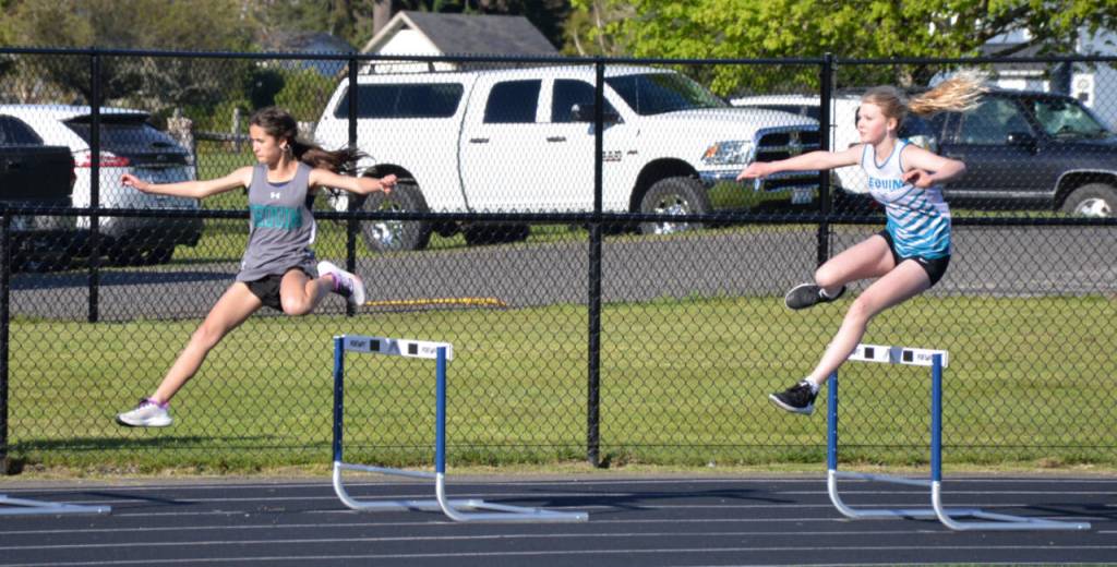 Photo by Caleb Gentry / Sequims Kalea Keate and Kylie Peters run the 200-meter hurdles at a league meet in Forks.
