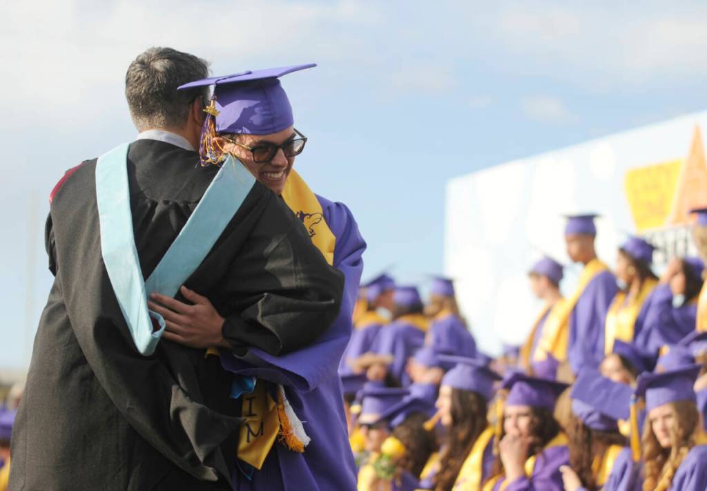 Sequim Gazette photo by Michael Dashiell / Graduating Sequim High School senior Sage Younger gets a big hug from dad Joe Younger, an SHS teacher who is retiring at the end of the school year, at the Sequim High graduation ceremony on June 14.