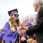 Sequim Gazette photo by Michael Dashiell / Staff-elected speaker Charley Sturm accepts her diploma from Sequim School Board director Larry Jeffryes at the Sequim High School graduation ceremony on June 14.