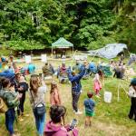 Photo by CasCadia Films
A crowd enjoys the Summertide Festival in the meadow of Websters Woods in 2023.