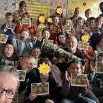Photo courtesy Keith Ross, Keiths Frame of Mind
Keith Ross and students in Nancy LeBlancs class at Franklin Elementary in Port Angeles hold cards of Eddie and and Elliott the eaglets after he gave a talk about his book The Rescue of Eddie & Elliott – A Bald Eaglet Adventure and on other birds hes photographed. (Editors note: some students faces have been covered due to parents requests. ­ MD)