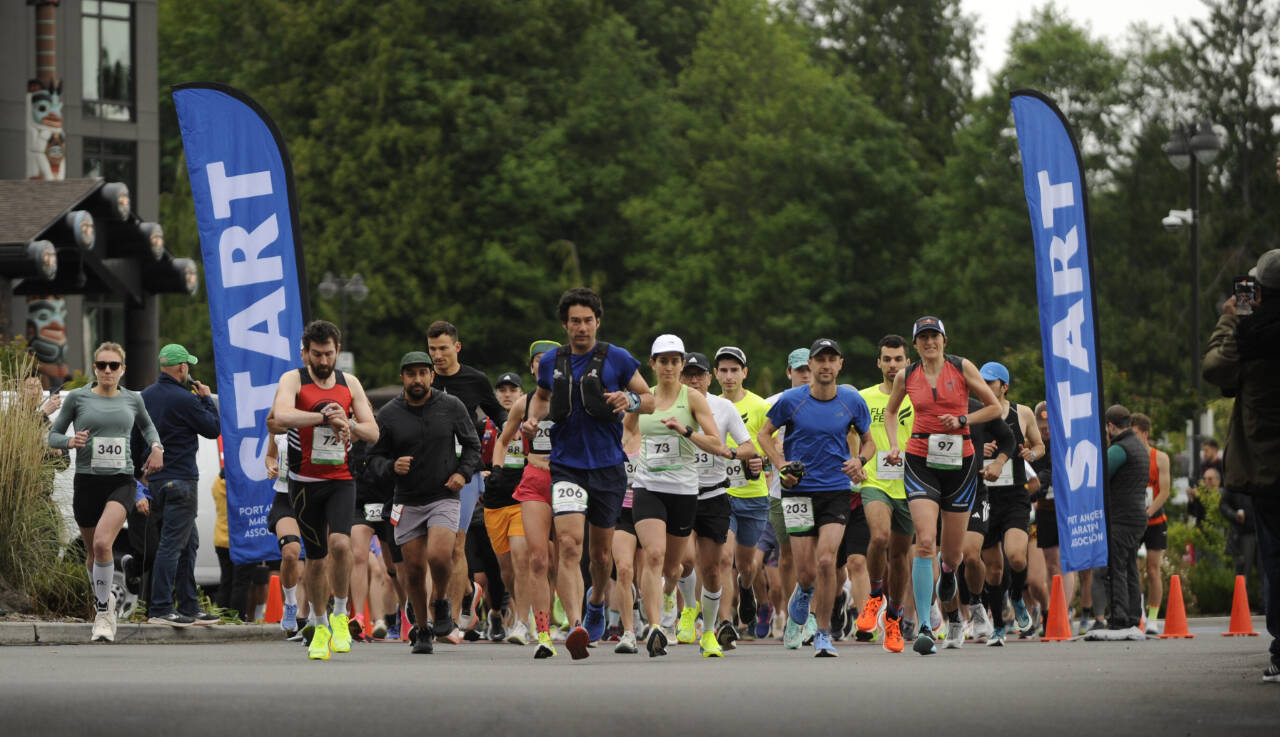 Sequim Gazette photo by Michael Dashiell / Runners break from the start of the North Olympic Discovery Marathon at 7 Cedars Resort on June 2. At left in red is the mens marathon winner Derek Binnersley.