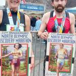 Photo by Pierre LaBossiere/Olympic Peninsula News Group
North Olympic Discovery Marathon winners Derek Binnersley and Natasha Parsons, both of Nanaimo, B.C., display their first-place posters on June 2.