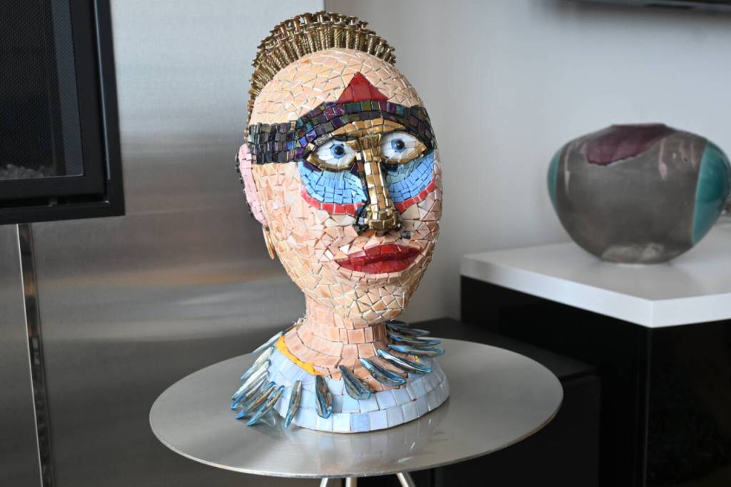 Christian Speidels Love Is Strange started as a wood sculpture but after cracking the artist shifted gears to add mosaic tiles.