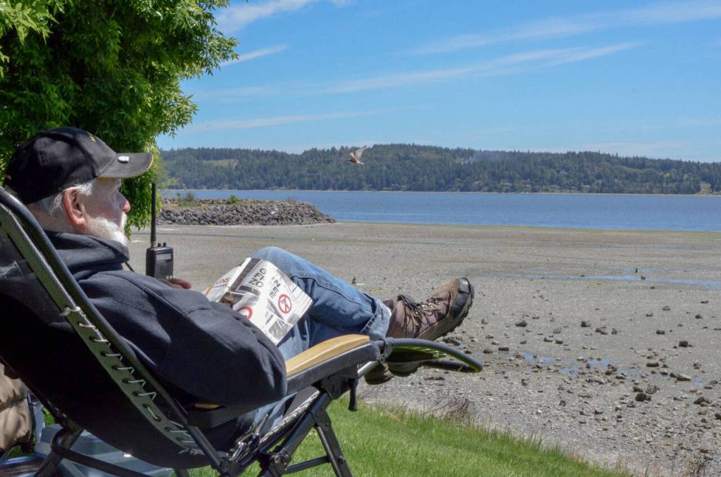 Sequim Gazette photo by Elijah Sussman / Tom Burns takes in the view at John Wayne Marina on low-tide day, June 6.