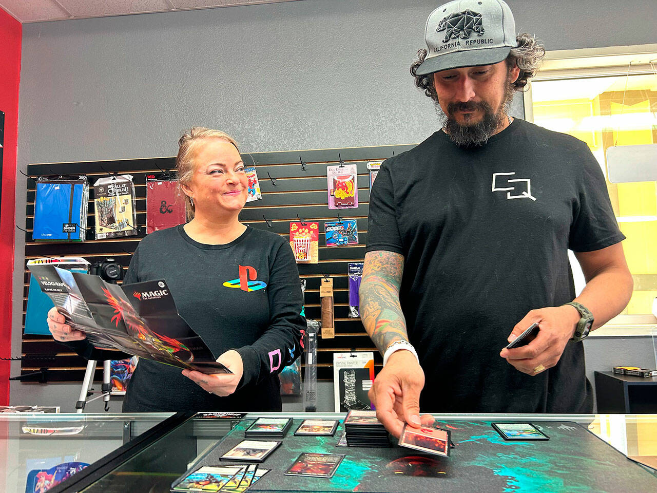 Sequim Gazette photo by Matthew Nash
Douglas Offenheiser sets up a game of Magic: the Gathering with his wife Paula in their new shop Cardquest Gaming in Sequim. Its open seven days a week off South Seventh Avenue behind Sergios and Sawadee.