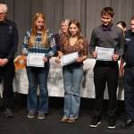 Photos by Jay Cline
At Sequim High Schools Scholarship Night on June 5, Sequim High seniors (from left) Libby Swanberg, Susannah Sharp and Aiden Albers receive Dale Kruse Memorial Scholarship funds from John McKenzie (far left) and John Brygider from Clallam County Fire District 3.
