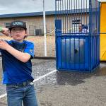 Sequim Gazette photo by Matthew Nash/ Fifth grader Kamdyn Galbreath celebrates with a flex after dunking Helen Haller Elementary principal Becky Stanton on June 11 during the schools annual Field Day.