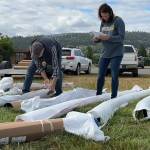 Sequim Gazette photo by Matthew Nash/ Noel Rich and Heidi Johnson catalogue playground equipment on June 12 for The Gathering Ground playground at Olympic View Church.