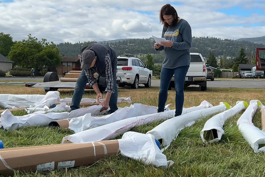Sequim Gazette photo by Matthew Nash/ Noel Rich and Heidi Johnson catalogue playground equipment on June 12 for The Gathering Ground playground at Olympic View Church.