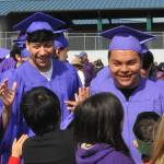 Sequim Gazette photo by Matthew Nash/ Seniors Brian Gallegos and Rodrigo Chavez greet students on the morning of their graduation day from Sequim High School.