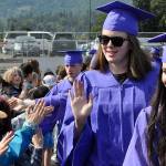 Sequim Gazette photo by Matthew Nash/ Sequim High seniors Dani Herman and Ava Welch high-five and give hellos to students during the annual SHS Grad Walk.