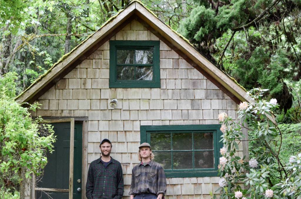 Sequim Gazette photo by Elijah Sussman / Brothers Willem (left) and Bergen stand in front of a cabin on their Quilcene property on My 29.