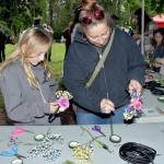Photo by Keith Thorpe/Olympic Peninsula News Group
Elora Wilson, 10, and her mother, Eria Wilson of Sequim, create solstice crowns to wear on their heads at a craft table in Websters Woods Sculpture Park at the Port Angeles Fine Arts Center during the Summertide Solstice Art Festival on June 15. The event featured music entertainment, poetry reading, crafts, food and games as a celebration of the upcoming beginning of summer and the longest day of the year.