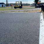 Sequim Gazette photo by Matthew Nash
Ryan Cortes with Beynon Sports fine tunes material recently placed around the Sequim School District track on July 19.