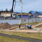 Photo courtesy of Sequim School District
Staff from Beynon Sports move and replace the pole vault pit at the Sequim athletic stadium. The runway and pad was close to a concrete wall  a safety concern both for athletes using the vault area and for individuals jumping from the wall onto the vault pad.