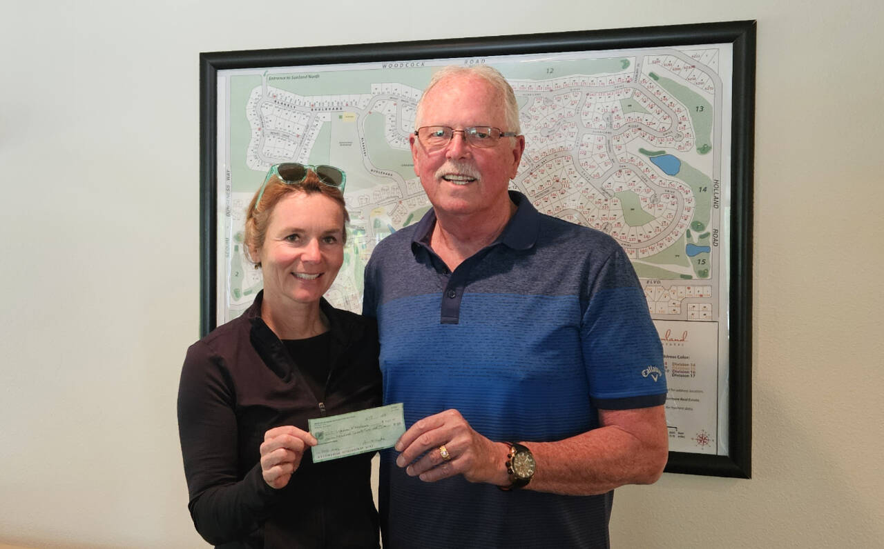Photo courtesy of Sequim Sunrise Rotary
Eric Mahnerd of Sequim Sunrise Rotary presents a $750 donation to Nicole Lepping, founder of the Sequim Wheelers, to help replace her organizations equipment.