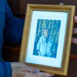 Sequim Gazette photo by Elijah Sussman / Diane Fatzinger holds a photo of her deceased partner Pamela Larsen at her home on June 18.