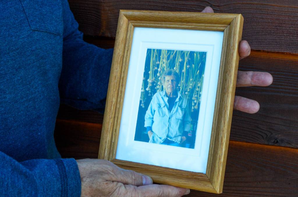 Sequim Gazette photo by Elijah Sussman / Diane Fatzinger holds a photo of her deceased partner Pamela Larsen at her home on June 18.