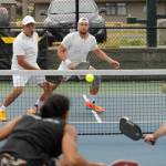 Sequim Gazette photo by Michael Dashiell / In background, Ryan Phasouk (left) and Mike Jelinek take on Moe Hussein Ahmed and Jon Olson in the gold medal match of the mens doubles 4.0+ division of the Sequim Fling Pickleball Tournament on June 29.
