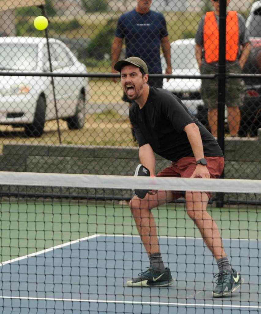 Sequim Gazette photo by Michael Dashiell / Jon Olson looks for a return shot in a mens doubles 4.0+ match at the Sequim Fling Pickleball Tournament on June 29.