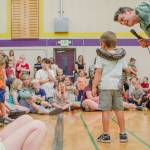 Sequim Gazette photo by Elijah Sussman / Arlo Svik faces audience while draped with constrictor.
