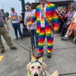 Photo courtesy Barbara Surber/ Michael Lowe stands by Nuala, a puppy being raised by Barbara Surber of Sequim for the Sequim Puppy Raisers with Guide Dogs for the Blind, during the Sequim Pride march on June 29.