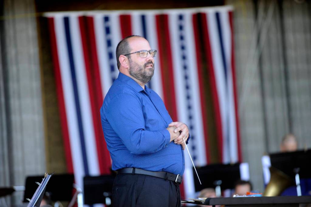 Sequim Gazette photo by Michael Dashiell / Sequim City Band director Tyler Benedict looks over the audience as the group prepares to start their A Patriotic Fourth program on July 4 at Carrie Blake Community Park.