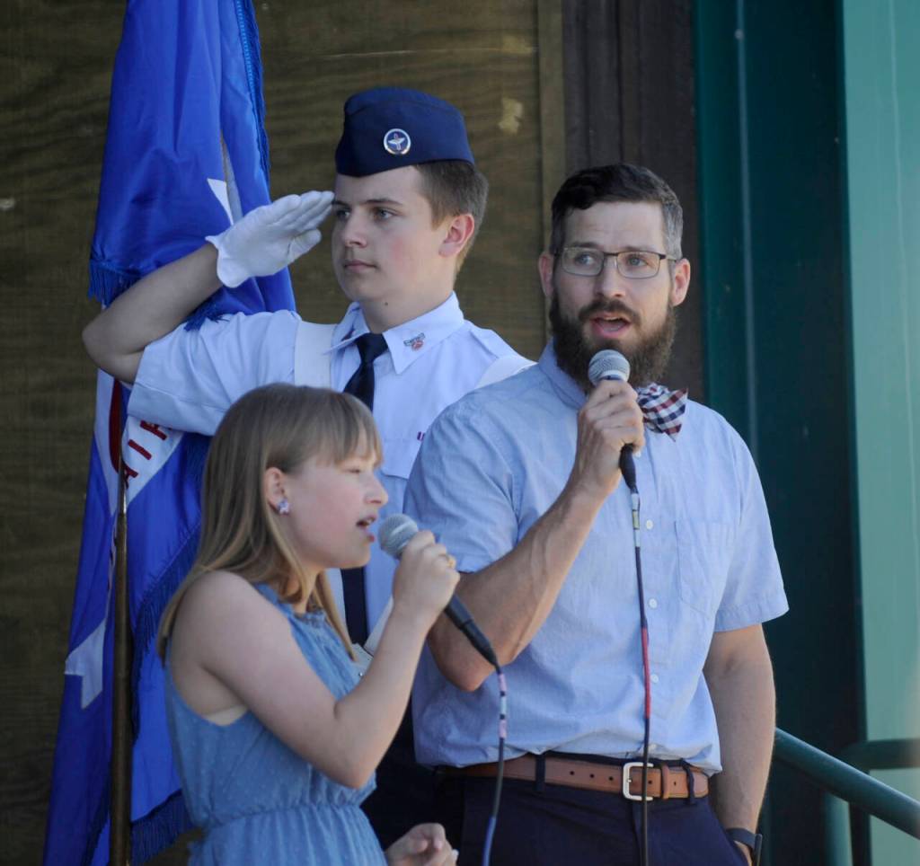 Sequim Gazette photo by Michael Dashiell
Evelyn and Lucas Fennell sing The Star Spangled Banner as Cadet Airman 1st Class Izaak Cameron La Tourette (background) and fellow Civil Air Patrol-Dungeness Unit cadets present the colors at the City of Sequims 2024 Independence Day Celebratio.