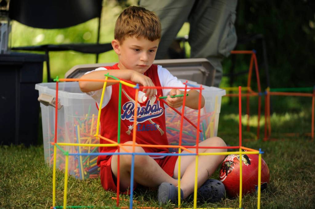 Sequim Gazette photo by Michael Dashiell
Henry Spooner, almost 6, of Sequim, concentrates on building a structure at the North Olympic Library Systems booth during the Sequim Independence Day Celebration.