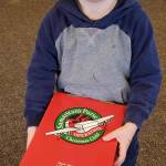 Benji Mullen of Sequim carries his gift-filled shoebox to be sent to a child far away.